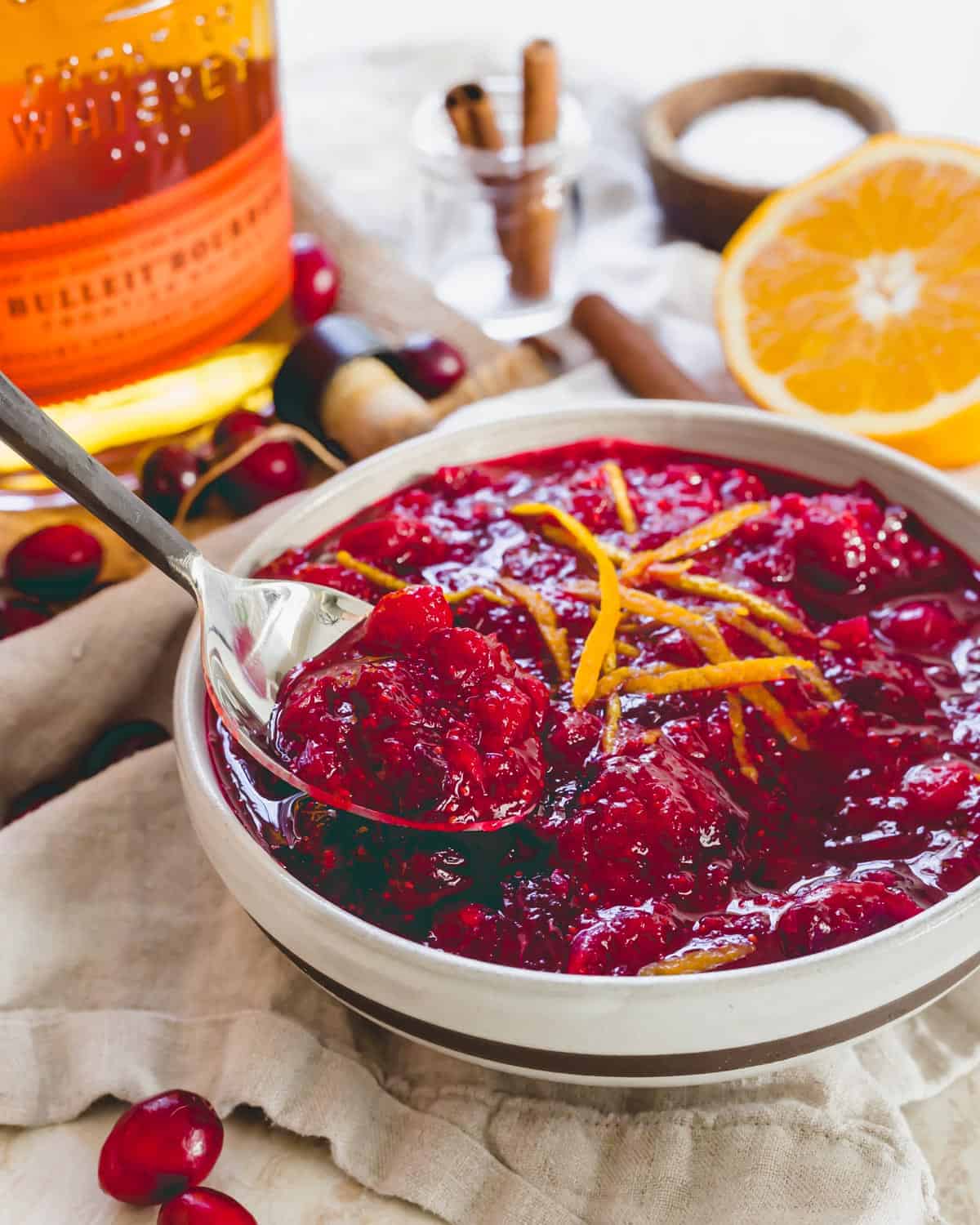 Bourbon cranberry sauce in a bowl with a spoon.