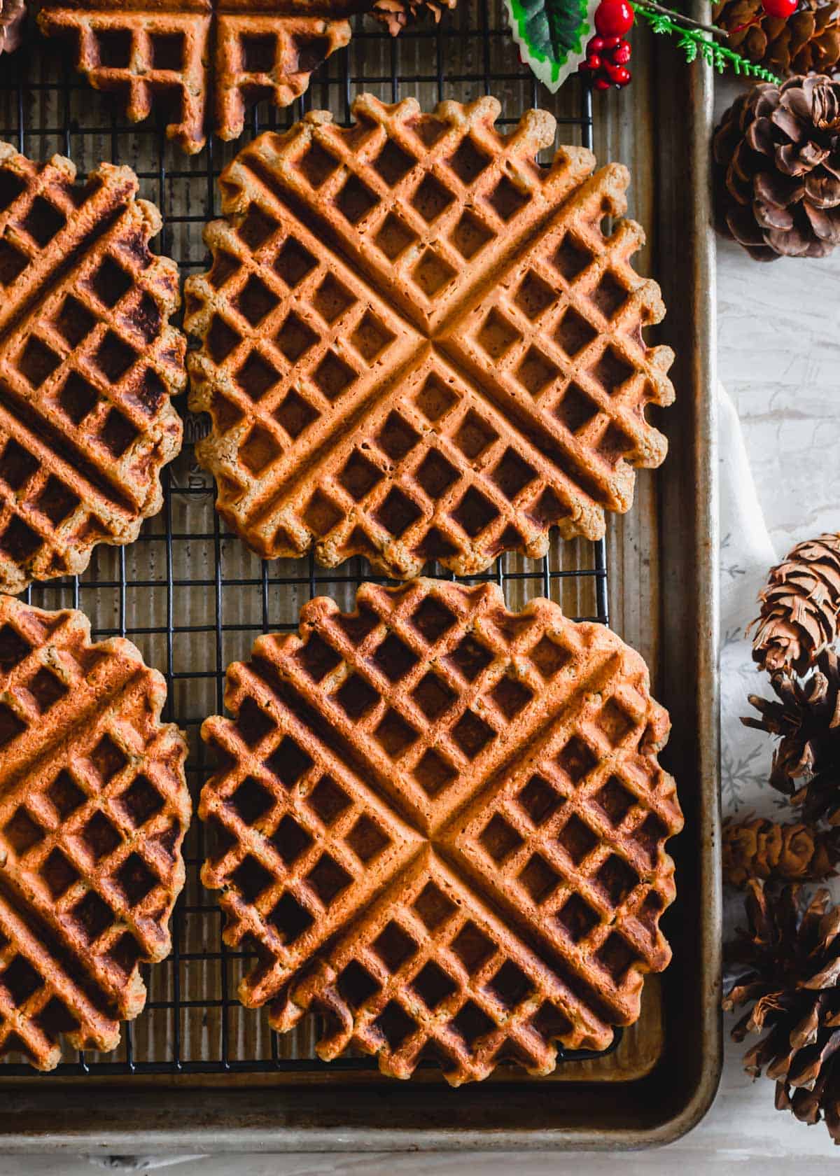 Gluten-free and vegan gingerbread waffles on a cooling rack.