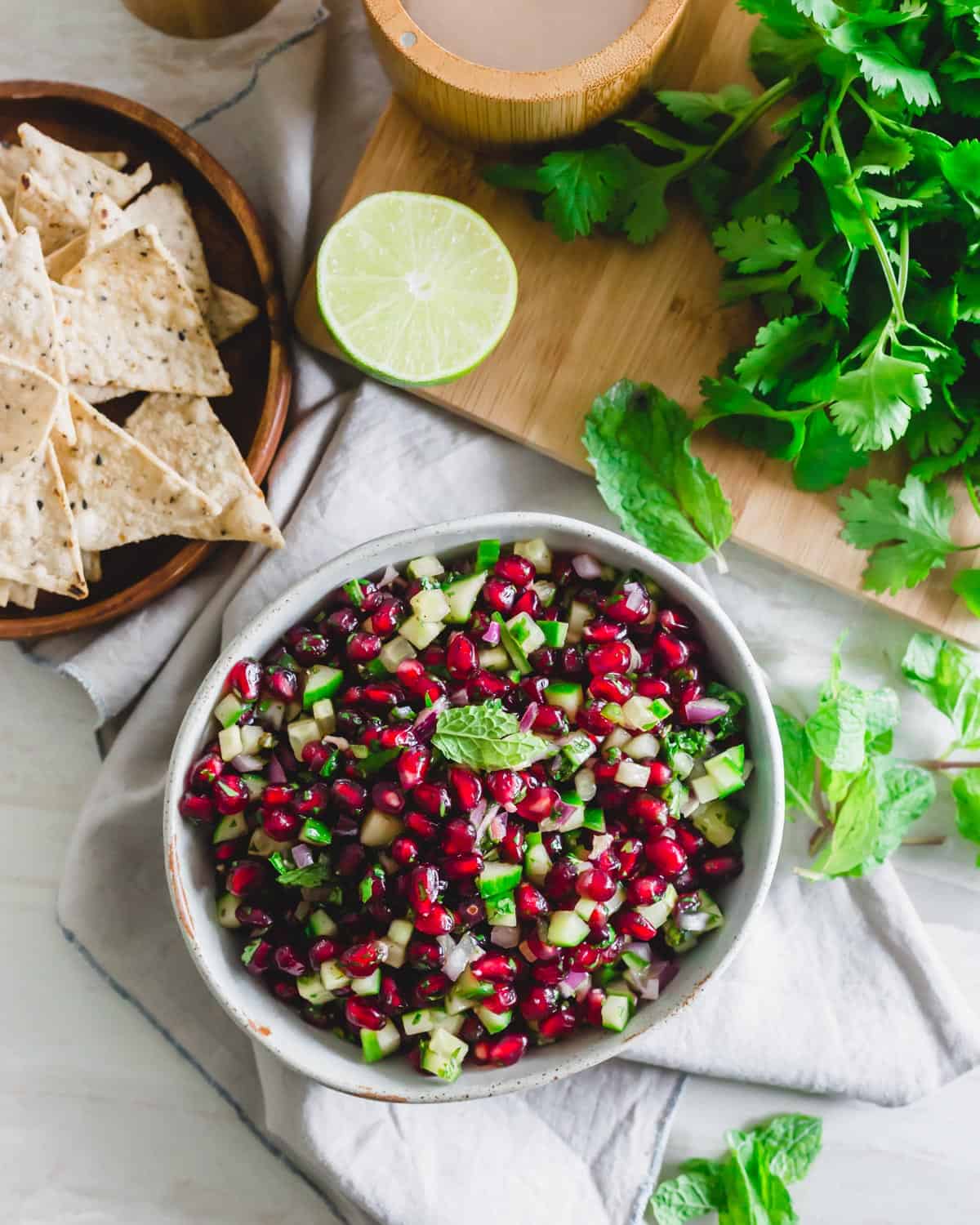 Pomegranate salsa in a bowl with mint garnish.