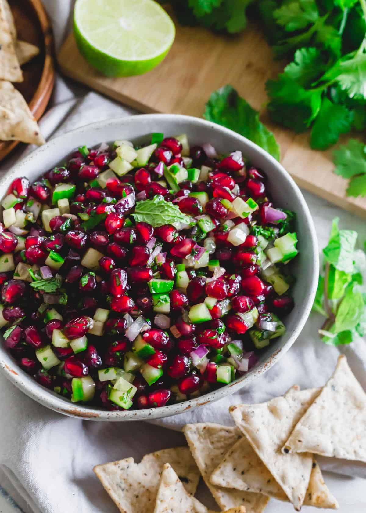 Pomegranate salsa recipe with cucumber, jalapeño, red onion and a honey lime dressing.