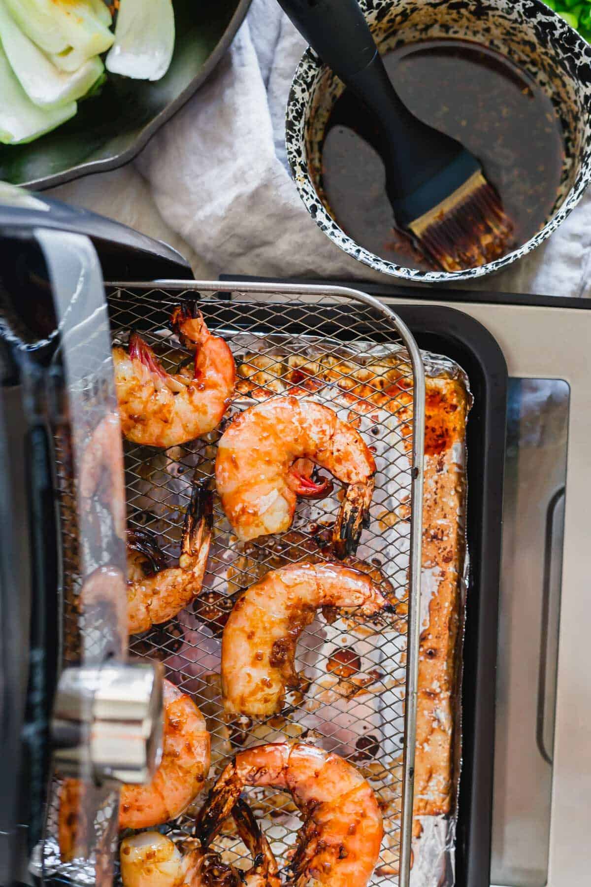 Air fried frozen shrimp in an air fryer.