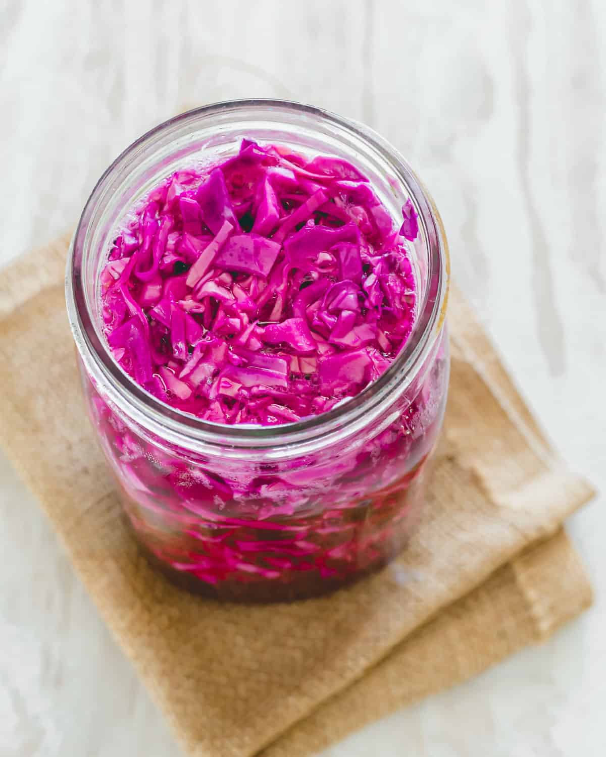 Red cabbage sauerkraut in a mason jar after 8 days of fermentation.