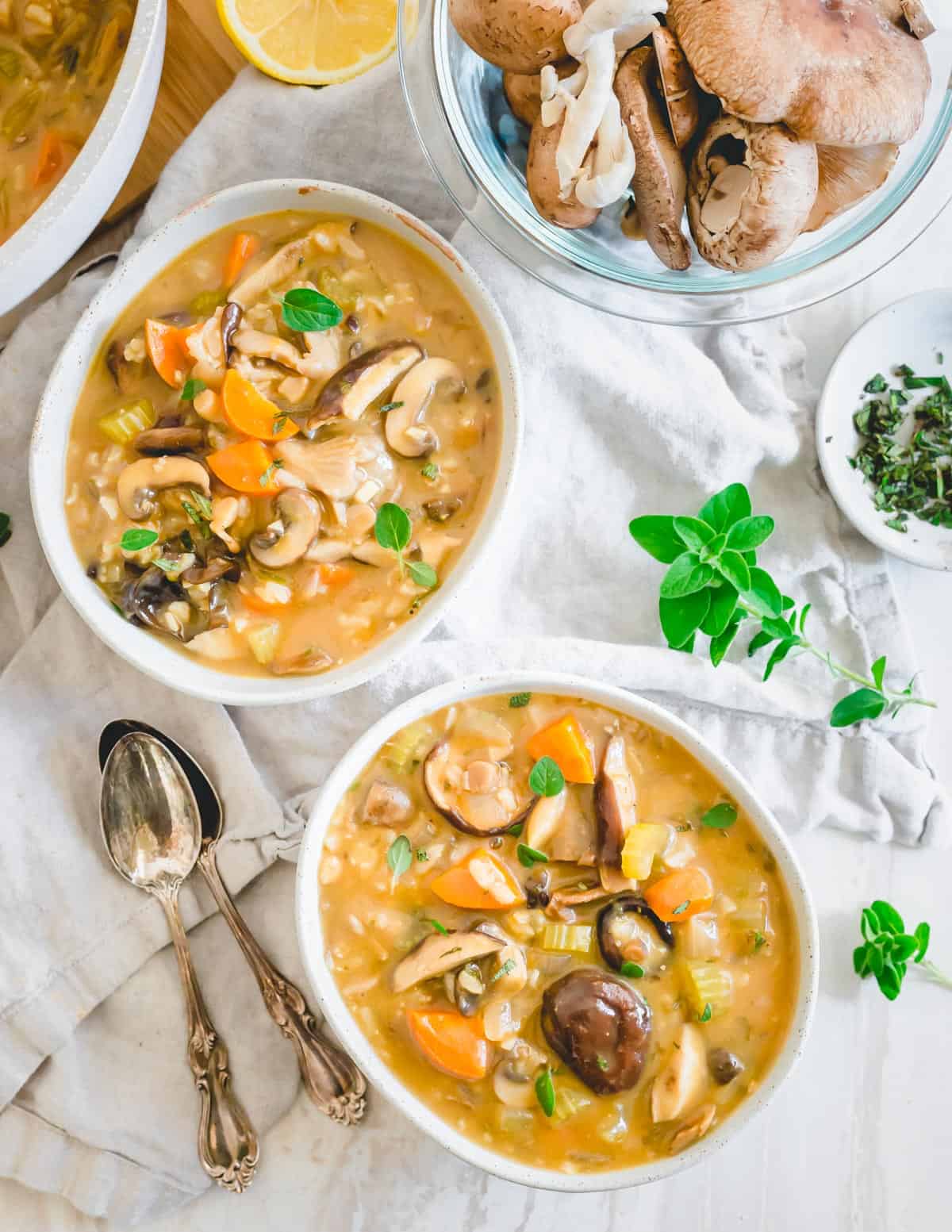 Wild mushroom soup in white bowls.