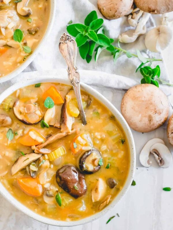 Wild mushroom soup in a bowl with silver spoon.