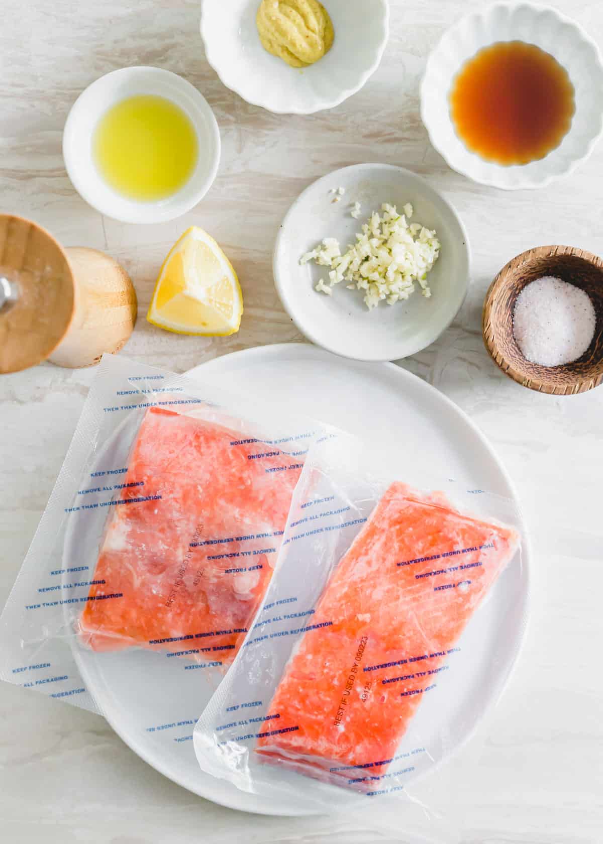 Frozen salmon filets with ingredients to make a maple mustard sauce.