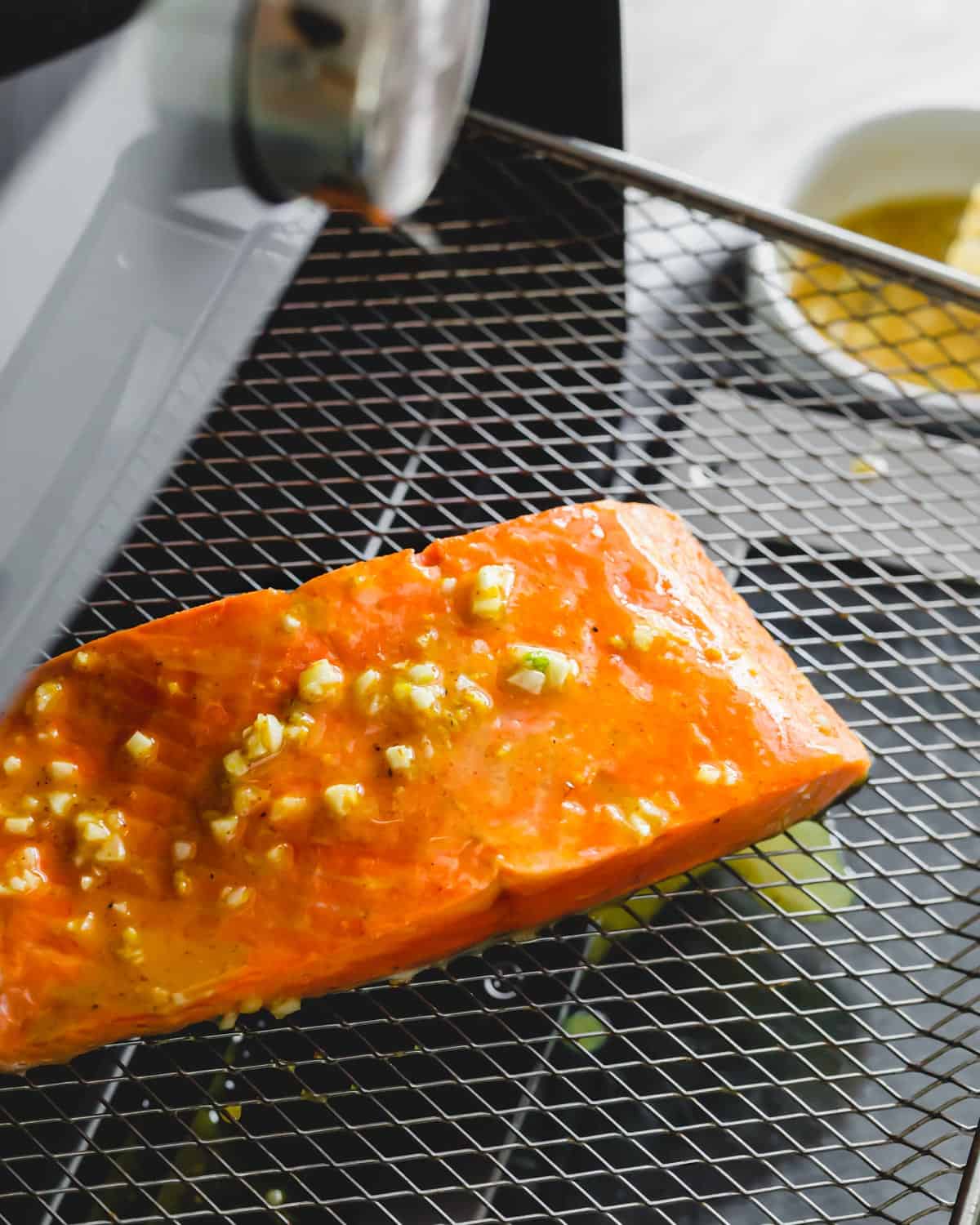 Frozen salmon filet in an air fryer.