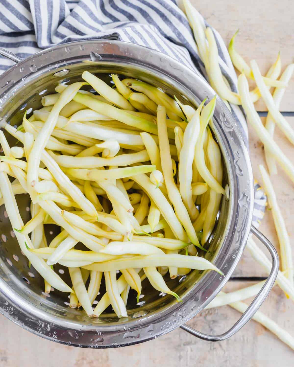 Yellow wax beans in a colander.