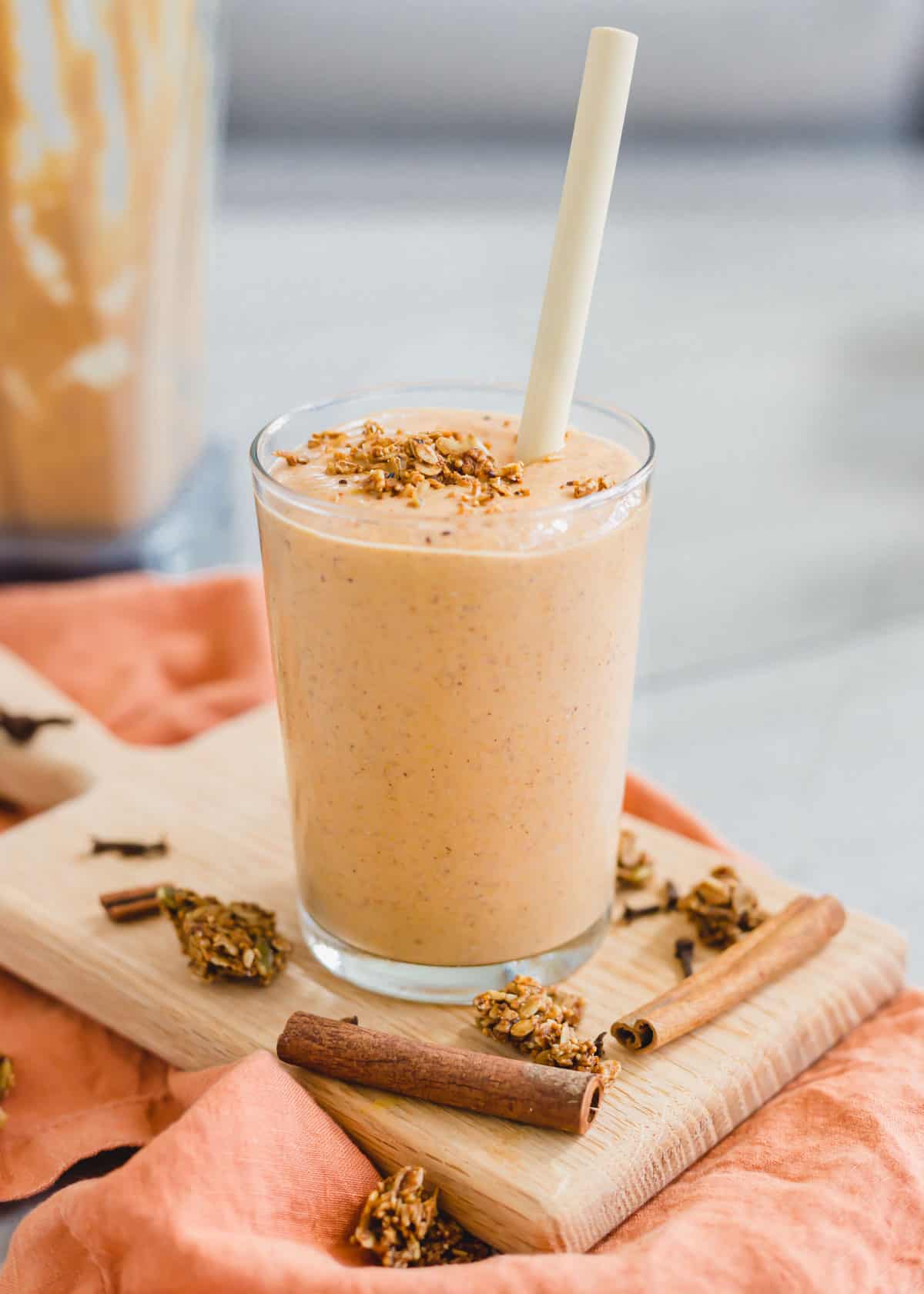 Creamy butternut squash smoothie recipe in a glass garnished with pumpkin granola.