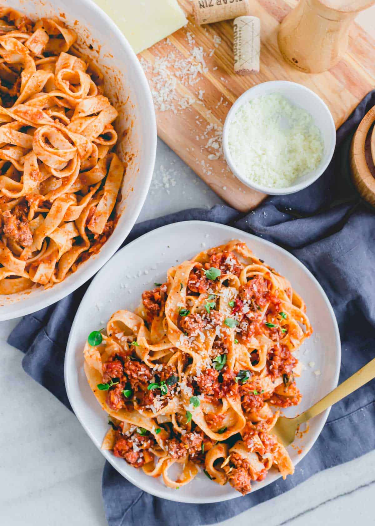 Ground lamb bolognese tossed with fresh pasta noodles and served with grated cheese and fresh herbs.