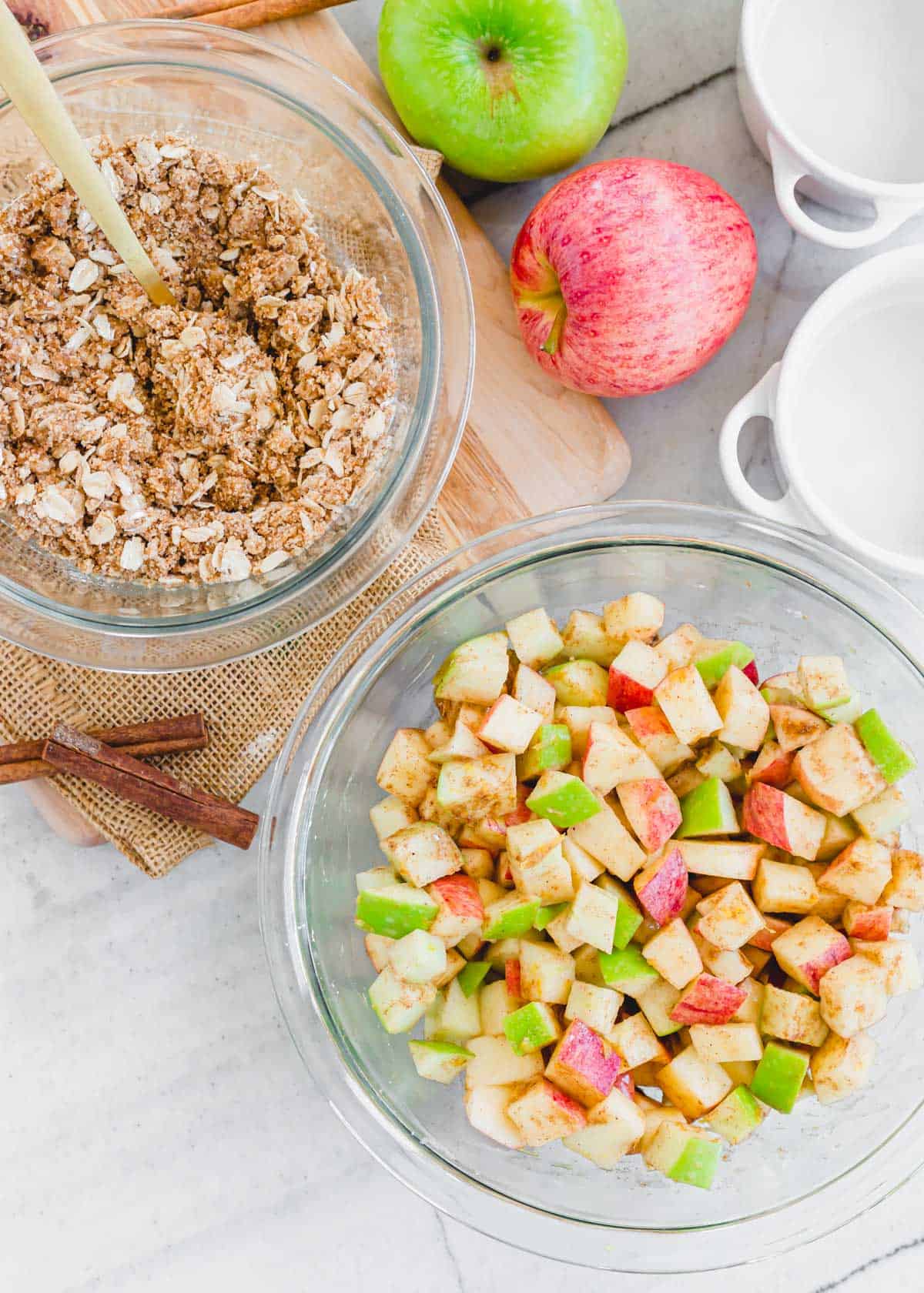 Ingredients to make apple crisp in the air fryer in glass bowls.