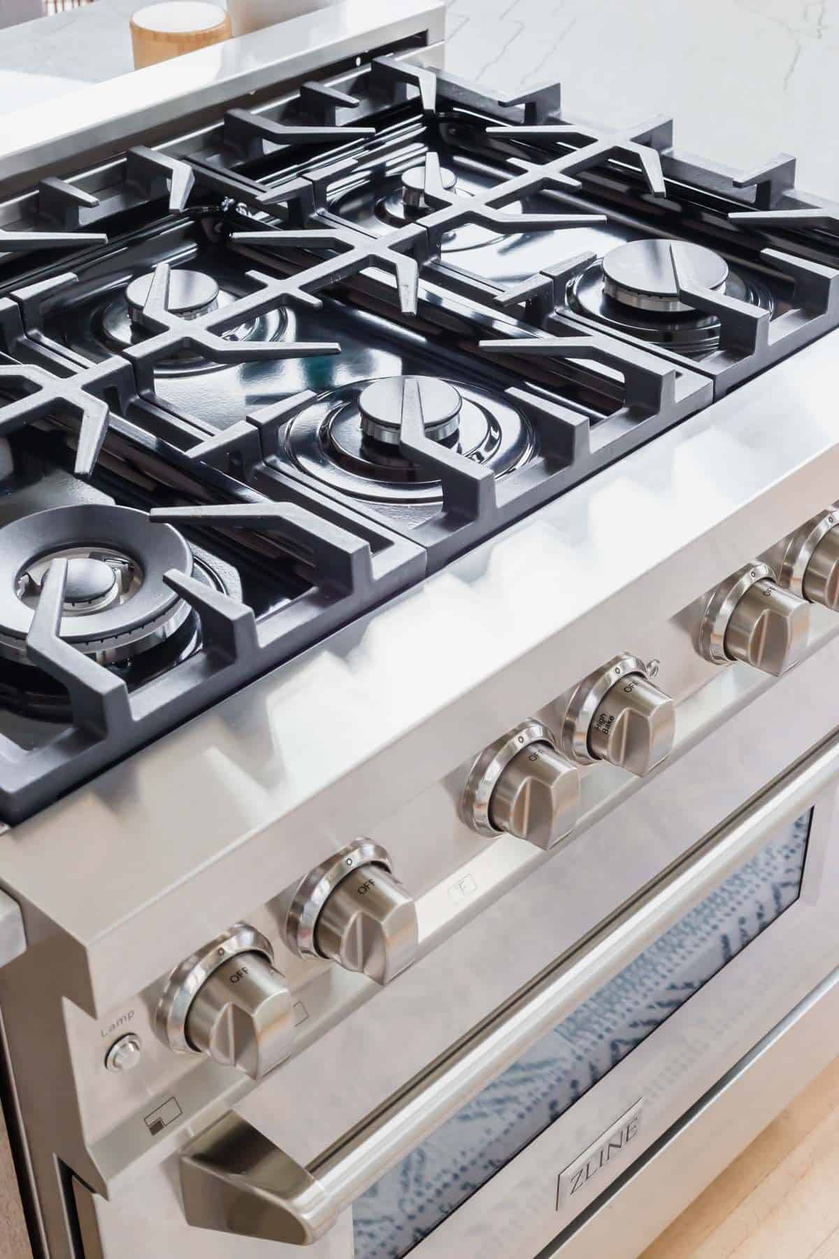 ZLINE 36" dual fuel range cooking top showcasing the Italian burners and cast iron grates.