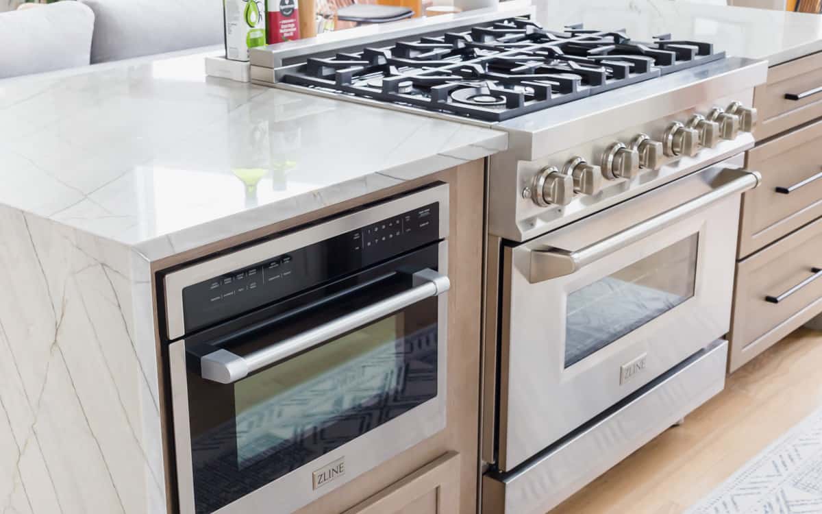 ZLINE dual fuel 36" stainless steel range and 24" built-in microwave oven installed in a kitchen island.