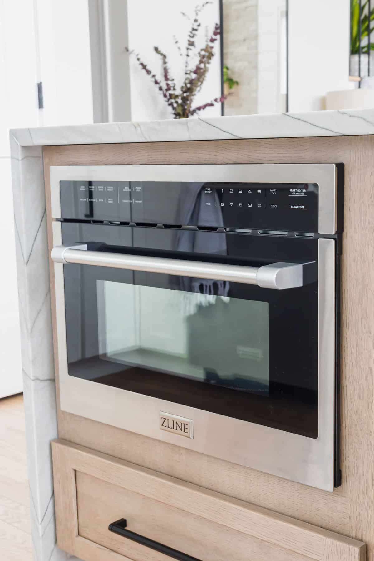 ZLINE MW0-24 built-in convection microwave oven installed in a kitchen island.