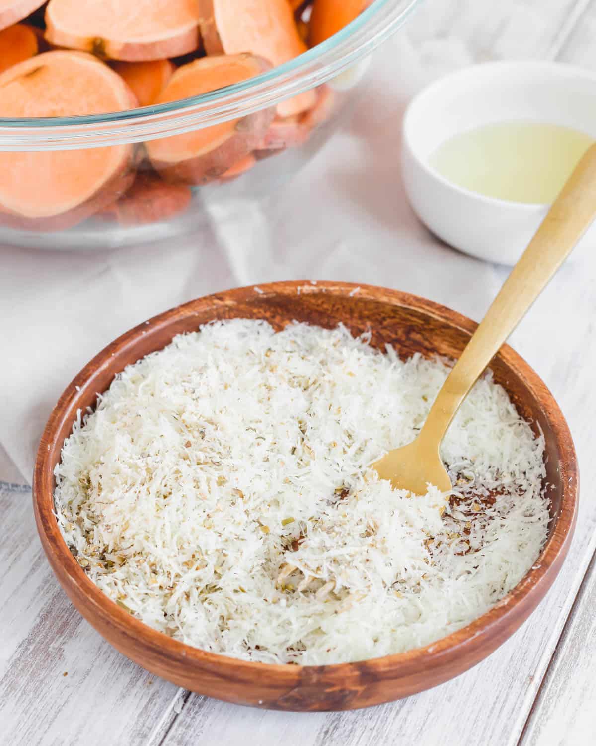 Parmesan herb mixture in a wooden dish with a fork.