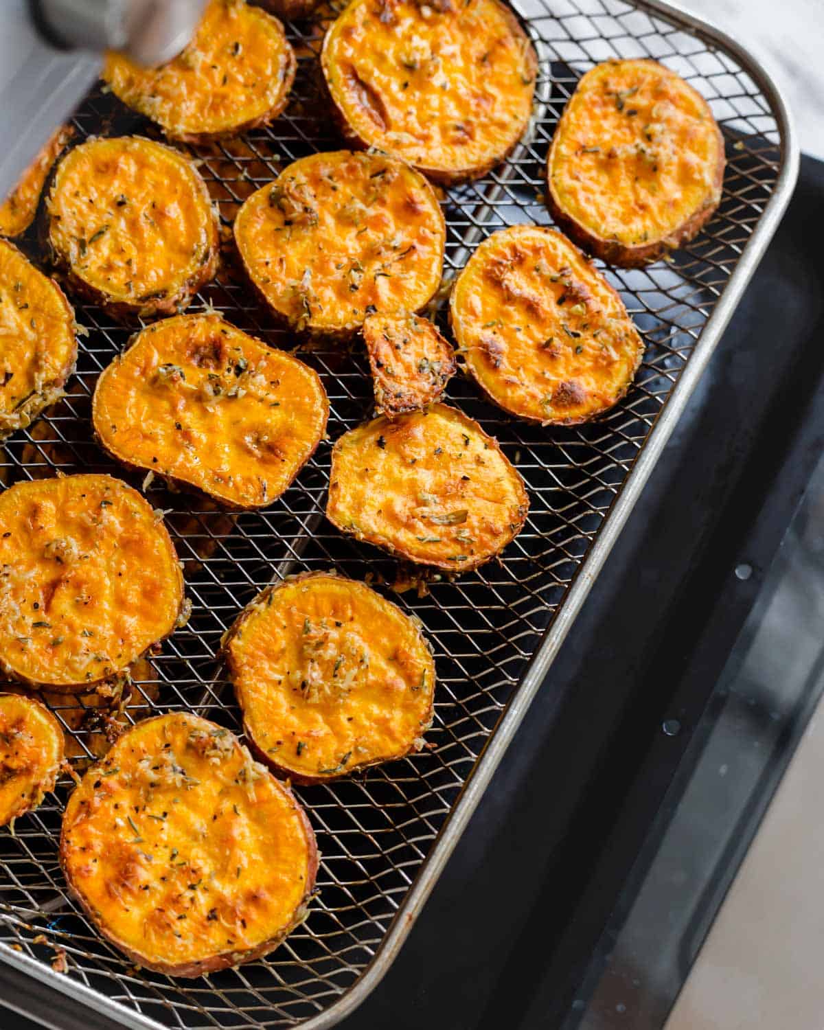 Sweet potatoes in an air fryer after roasting.