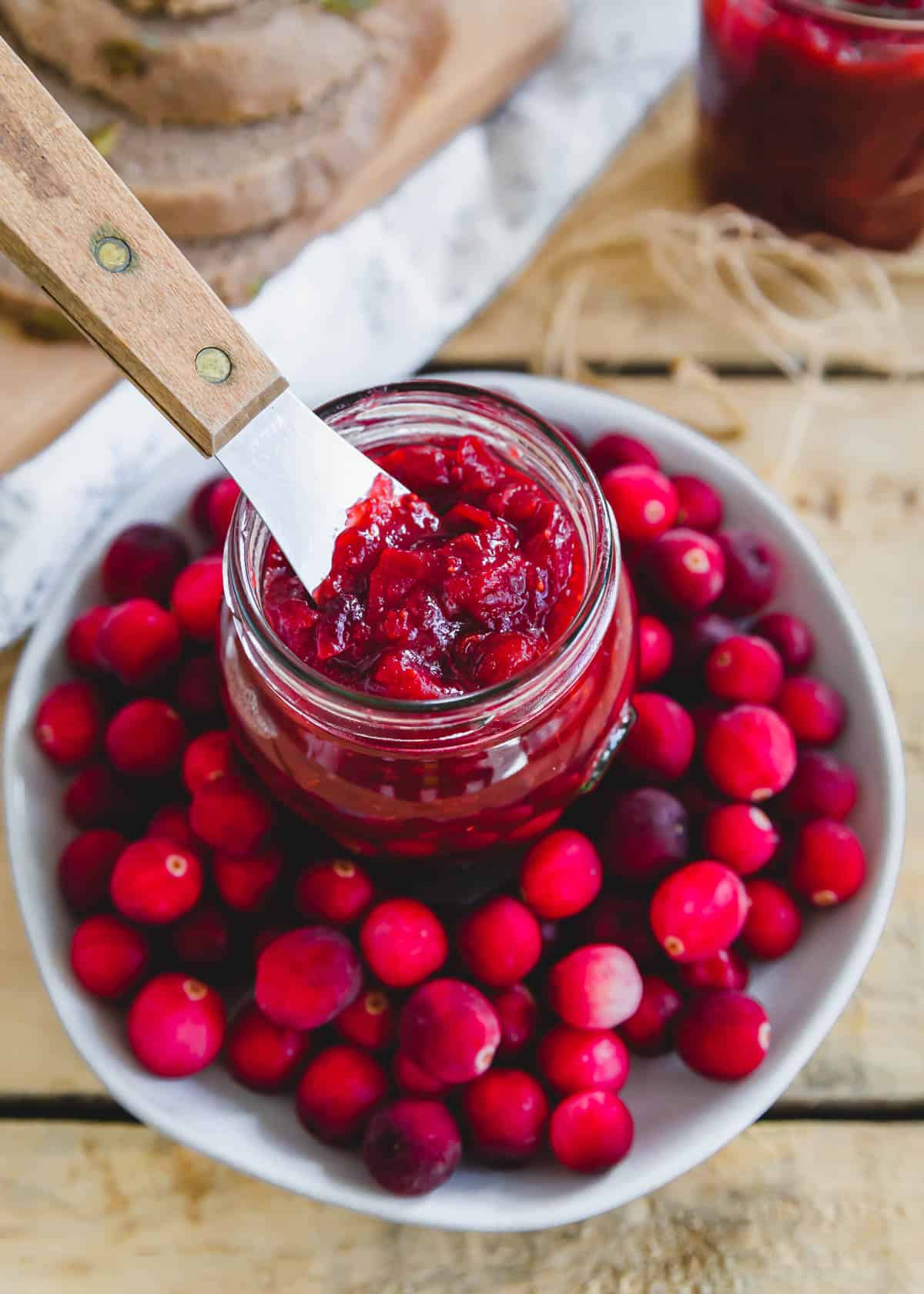 Homemade cranberry jam recipe with a small spatula.