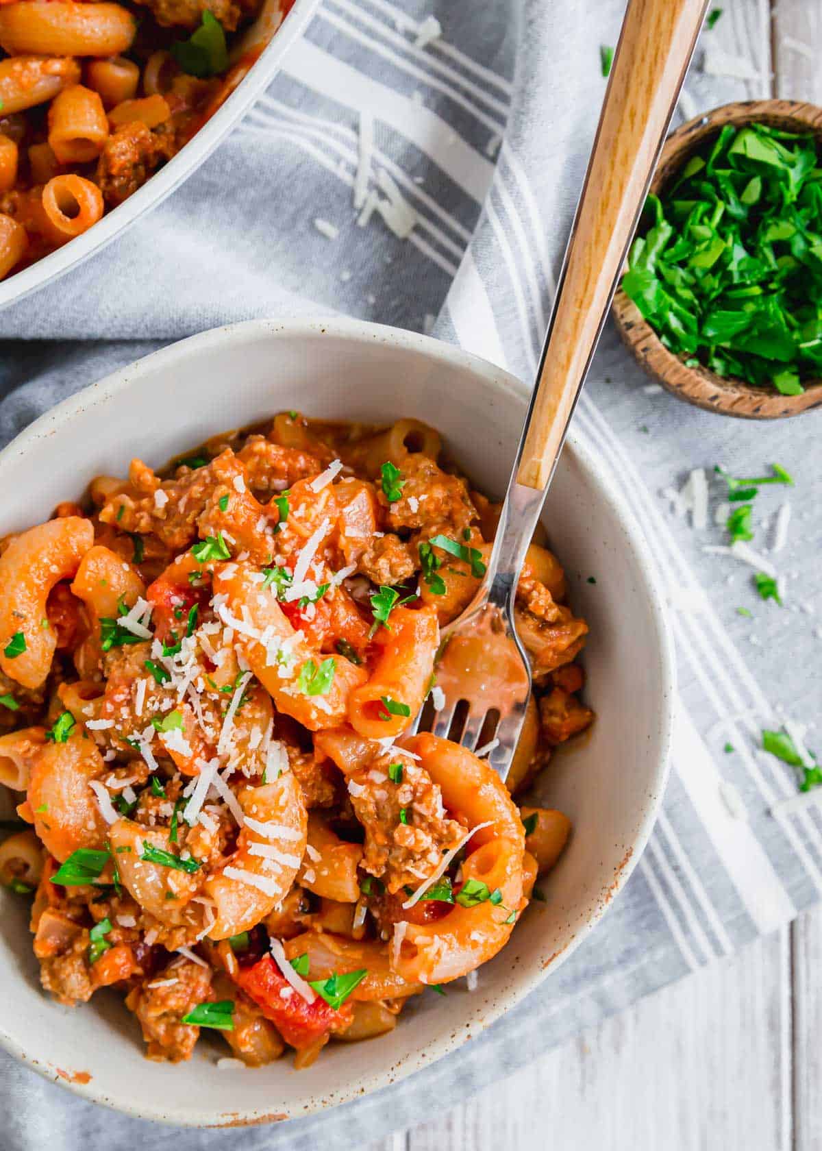 Ground beef and pasta recipe in a bowl with a fork.