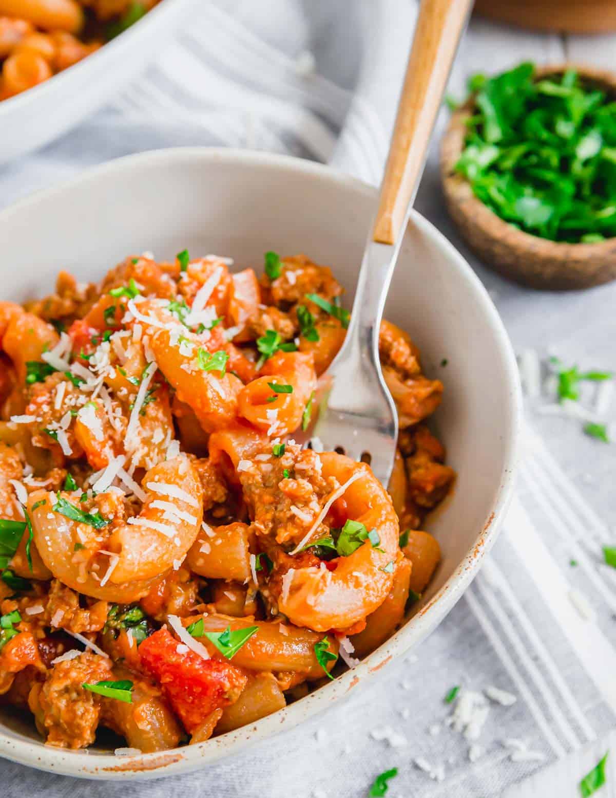 Ground beef pasta dish in a bowl with a fork.