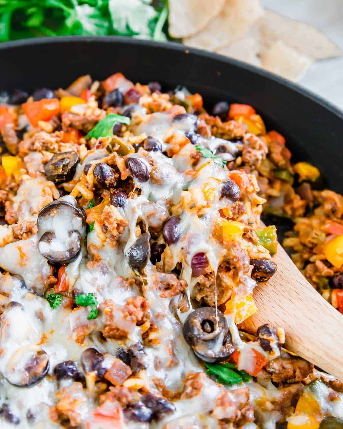 Mexican ground beef skillet recipe with a wooden serving spatula.