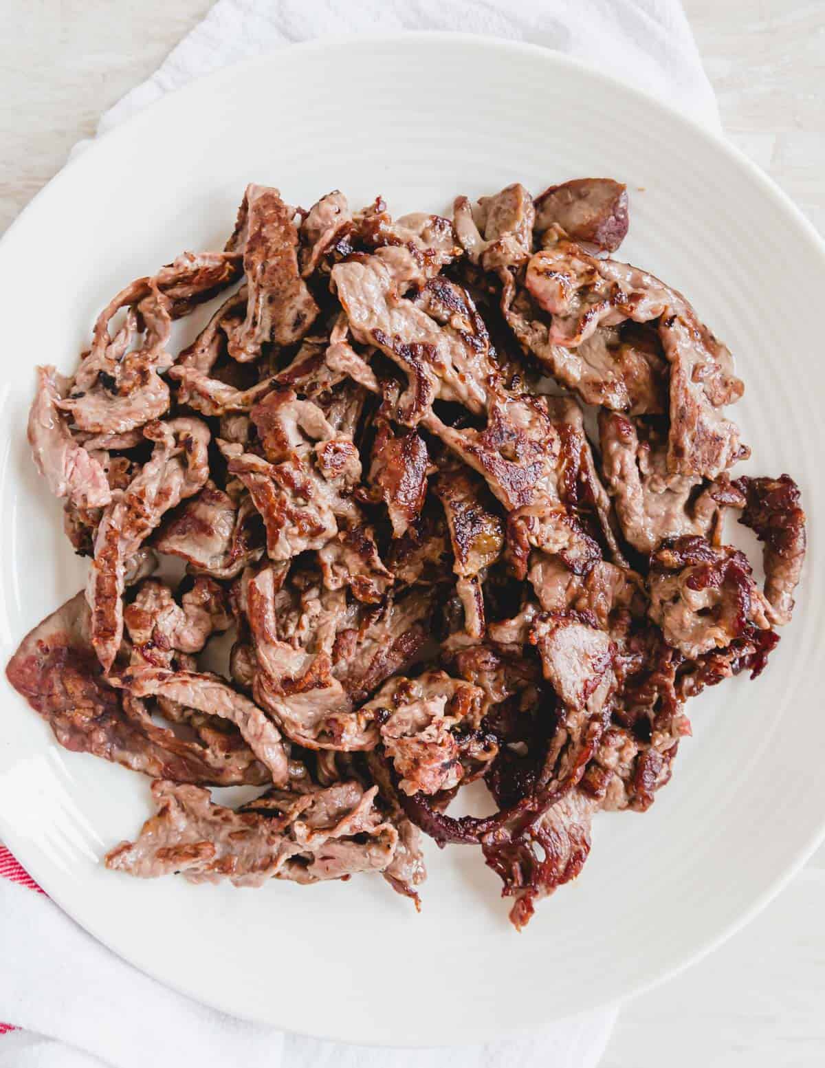 Crispy pan-fried shaved beef on a plate.