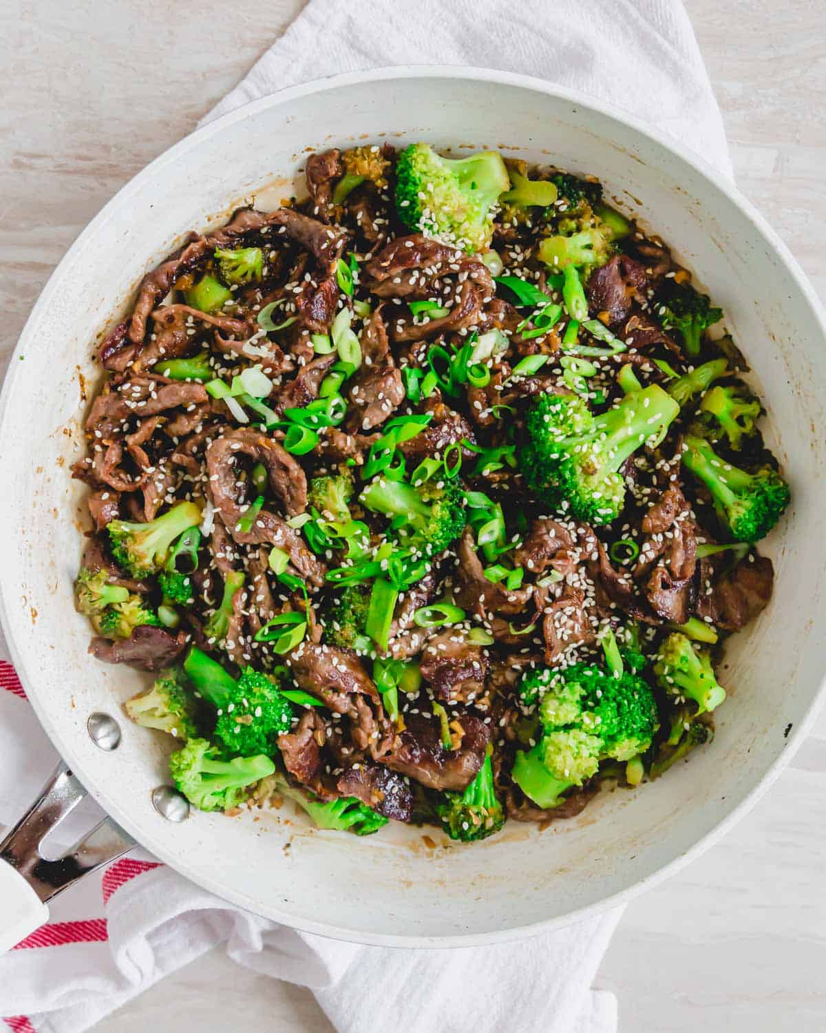 Shaved beef recipe with broccoli in a skillet.