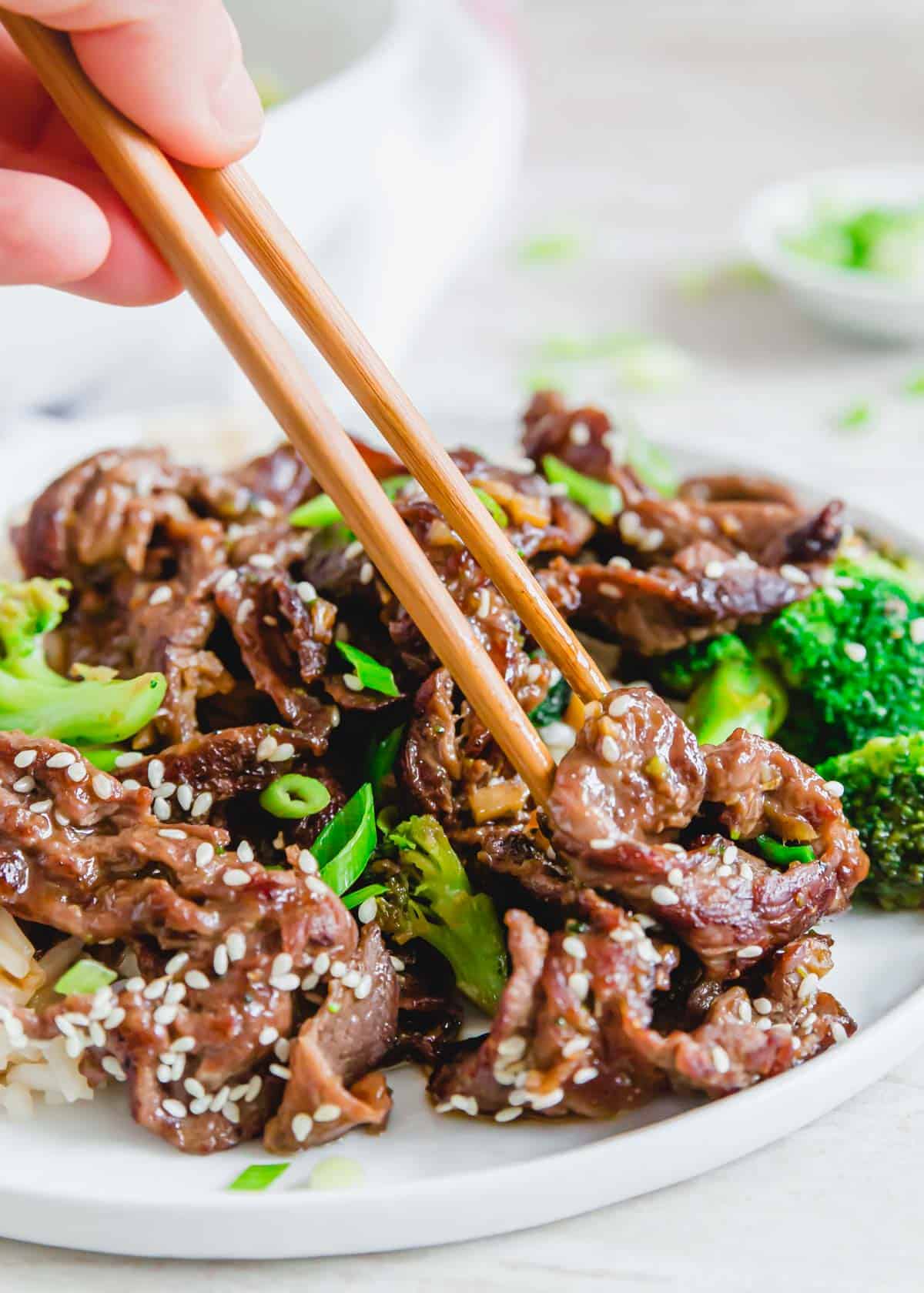 Stir fry shaved beef steak recipe with chopsticks.