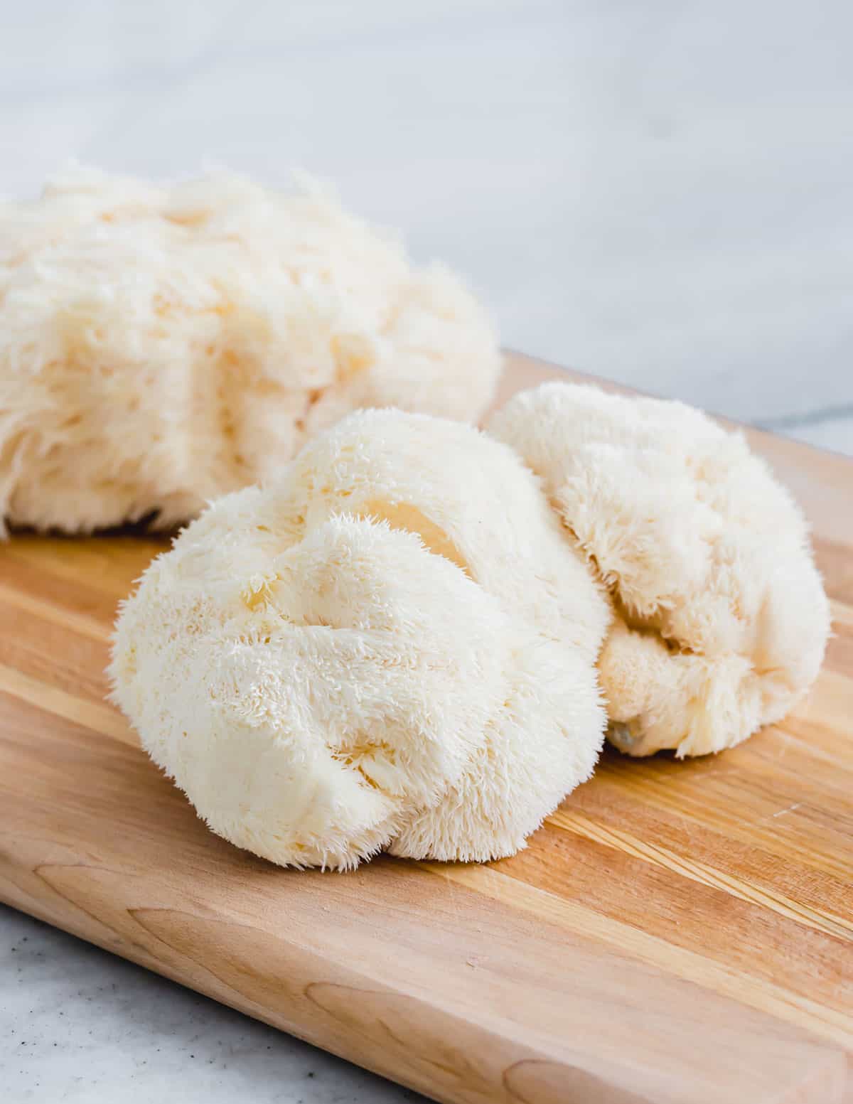 Lion's mane mushrooms on a cutting board.