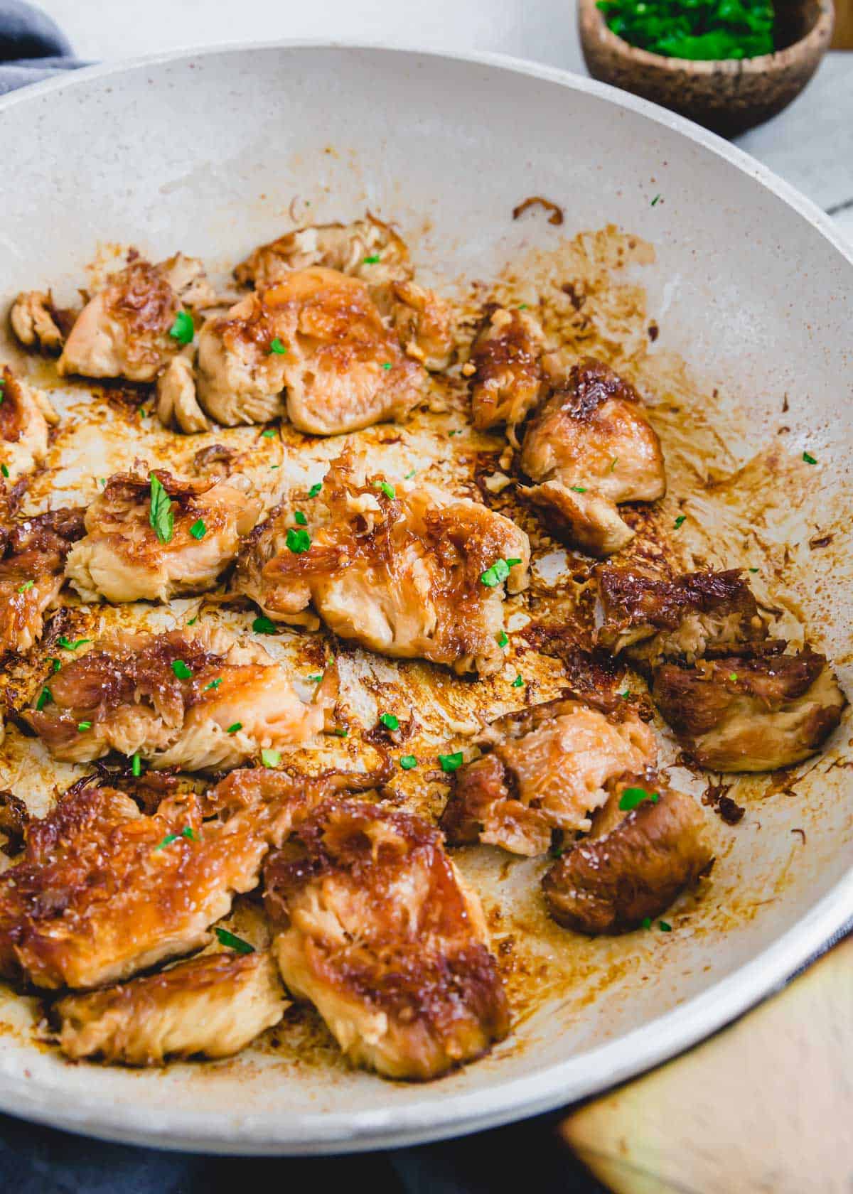 Sauteed lion's mane mushrooms in a white skillet.