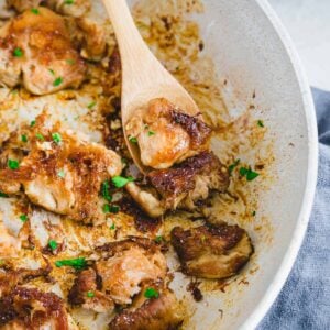 Lion's Mane mushrooms in a pan with a wooden spoon.