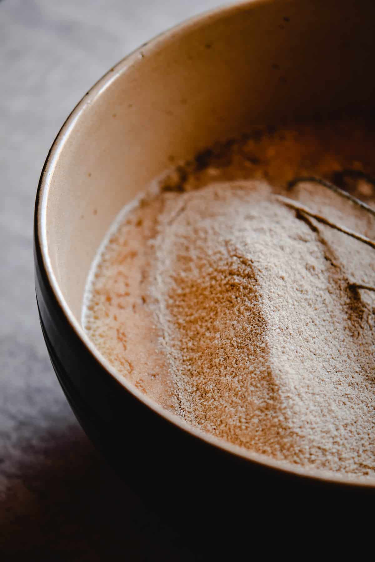 buckwheat flour in a bowl for baking with a wire whisk.