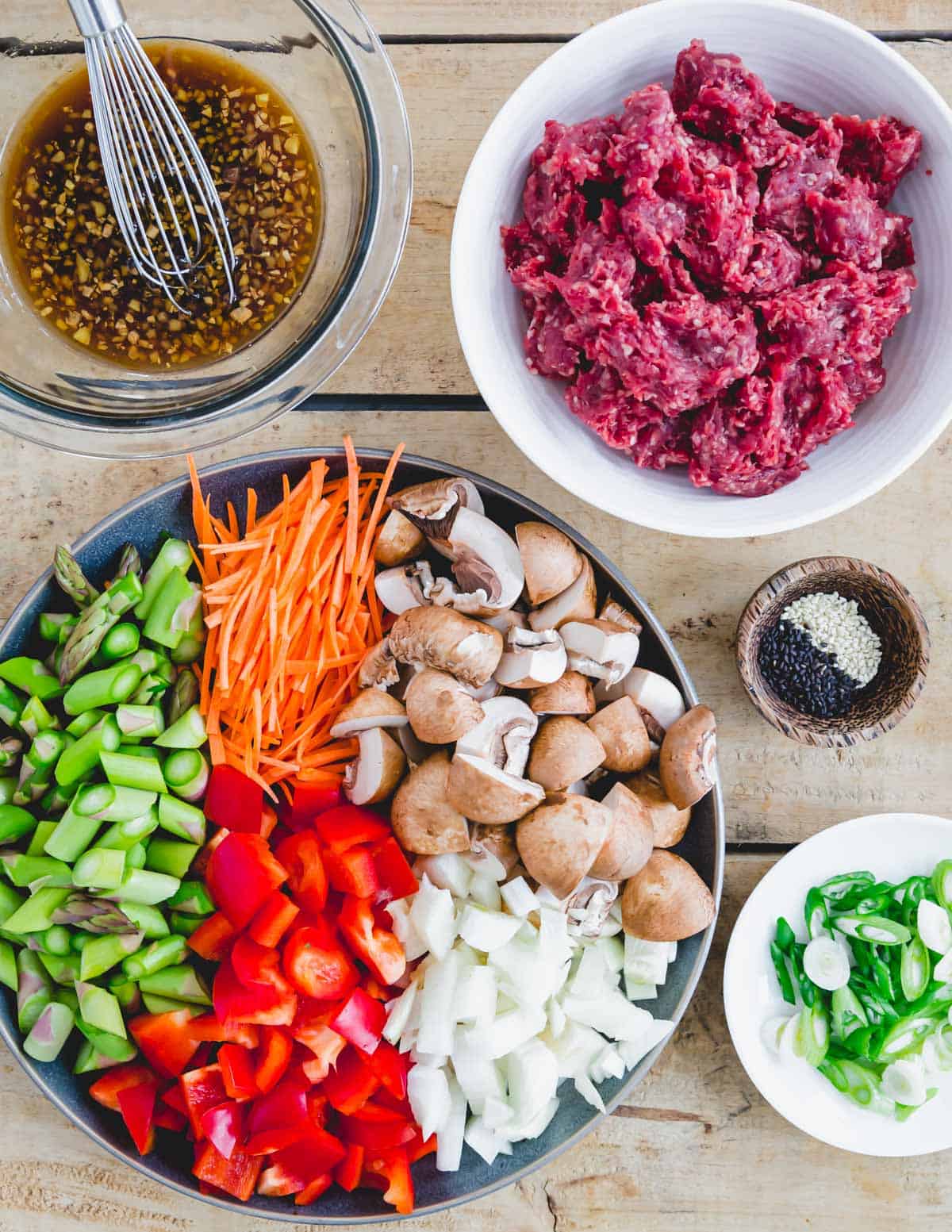 Ground beef, raw vegetables, stir fry sauce and sesame seeds to make an easy ground beef stir fry recipe.