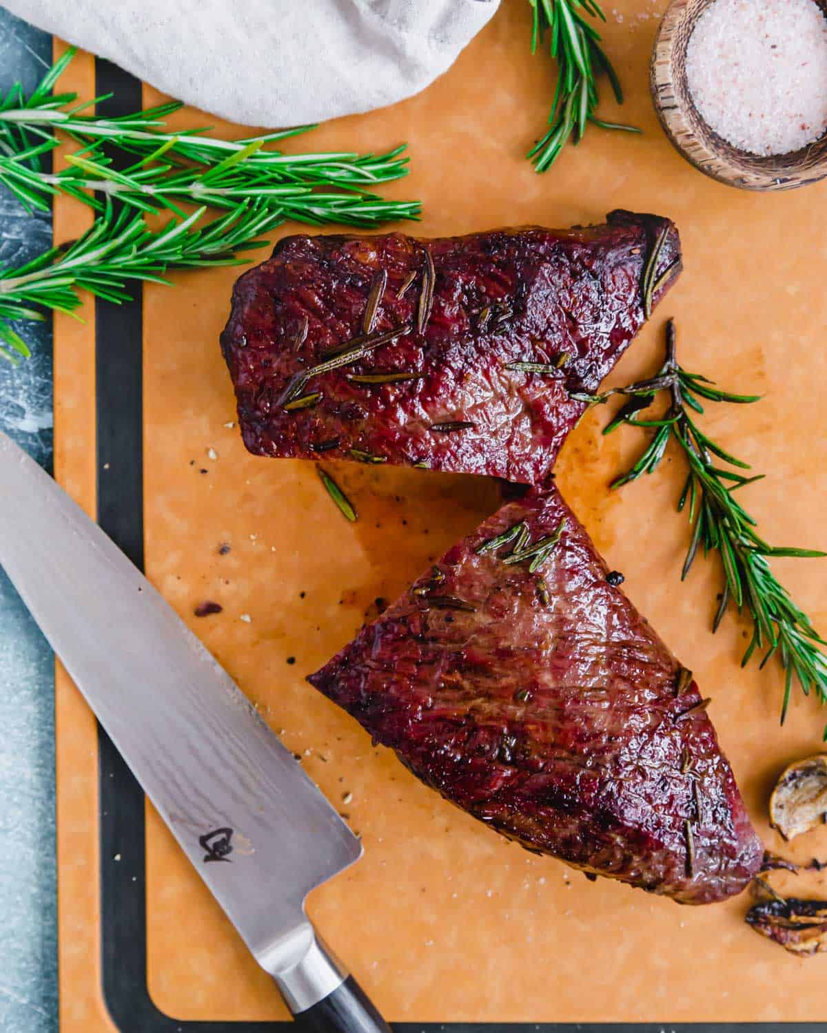 Reverse pan seared tri tip recipe cut in half where the grains converge.