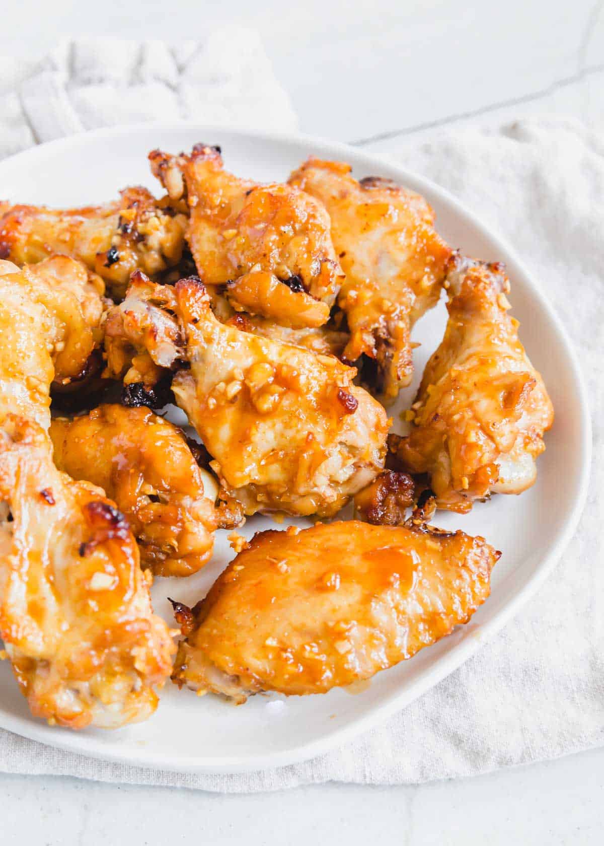 Marinated baked chicken wings on a plate.