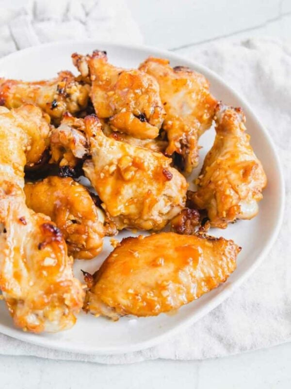 Marinated baked chicken wings on a plate.
