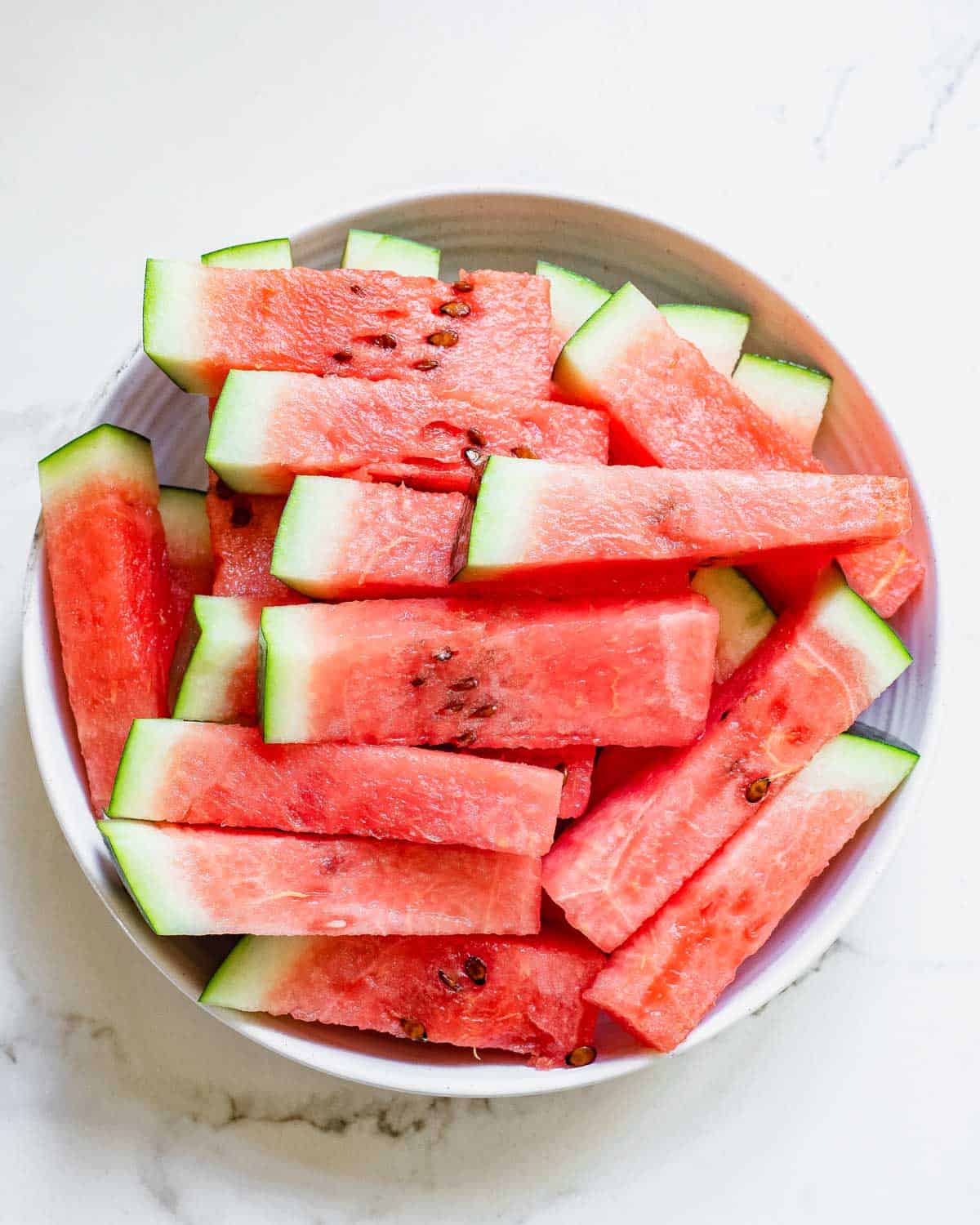 Watermelon sticks in a bowl.