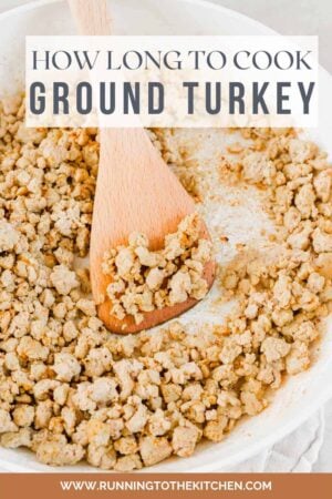 Seasoned ground turkey in a skillet with spatula.