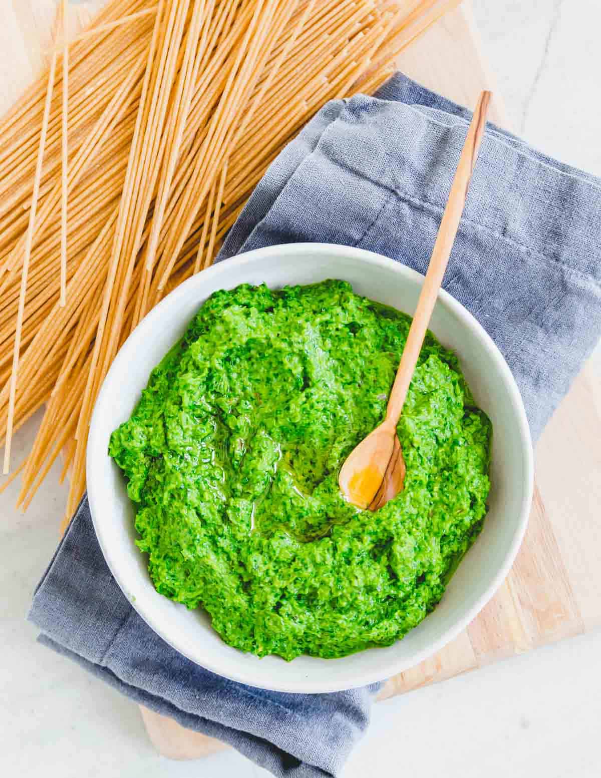 Ramp pesto in a bowl with dried spaghetti on the side.