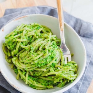 Ramp pesto on spaghetti in a bowl with a fork.