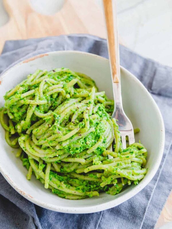 Ramp pesto on spaghetti in a bowl with a fork.