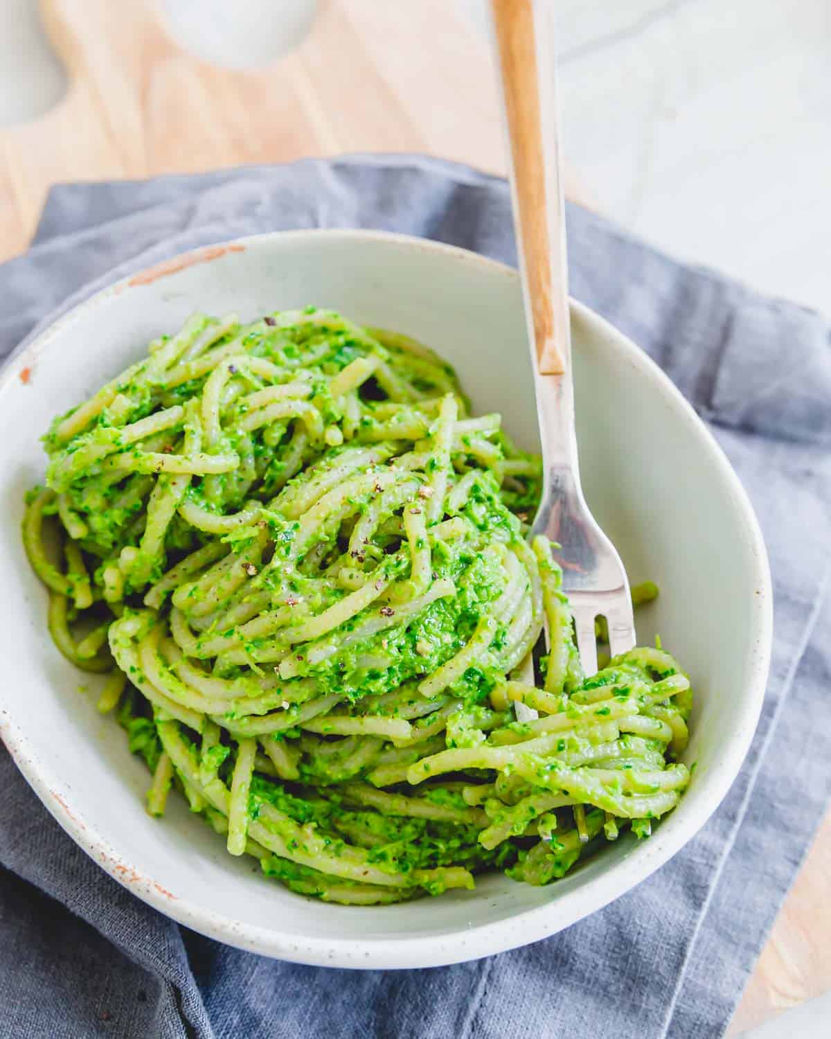 Ramp pesto on spaghetti in a bowl with a fork.