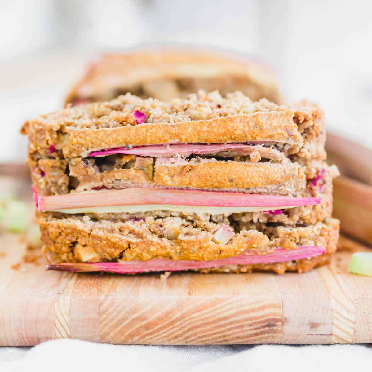 Rhubarb walnut bread slices stacked on top of each other.