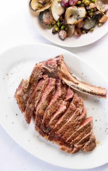 Sliced steak on a white plate.
