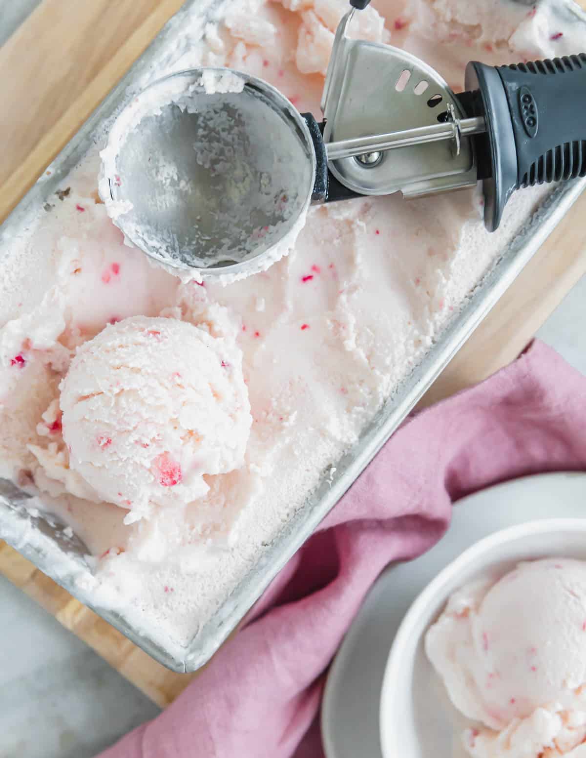 Strawberry vanilla kefir ice cream with ice cream scoop.