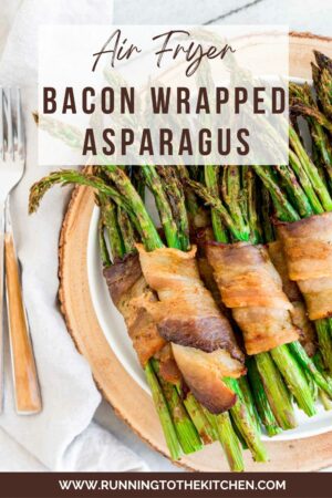 Bacon wrapped asparagus bundles cooked in the air fryer on a plate.