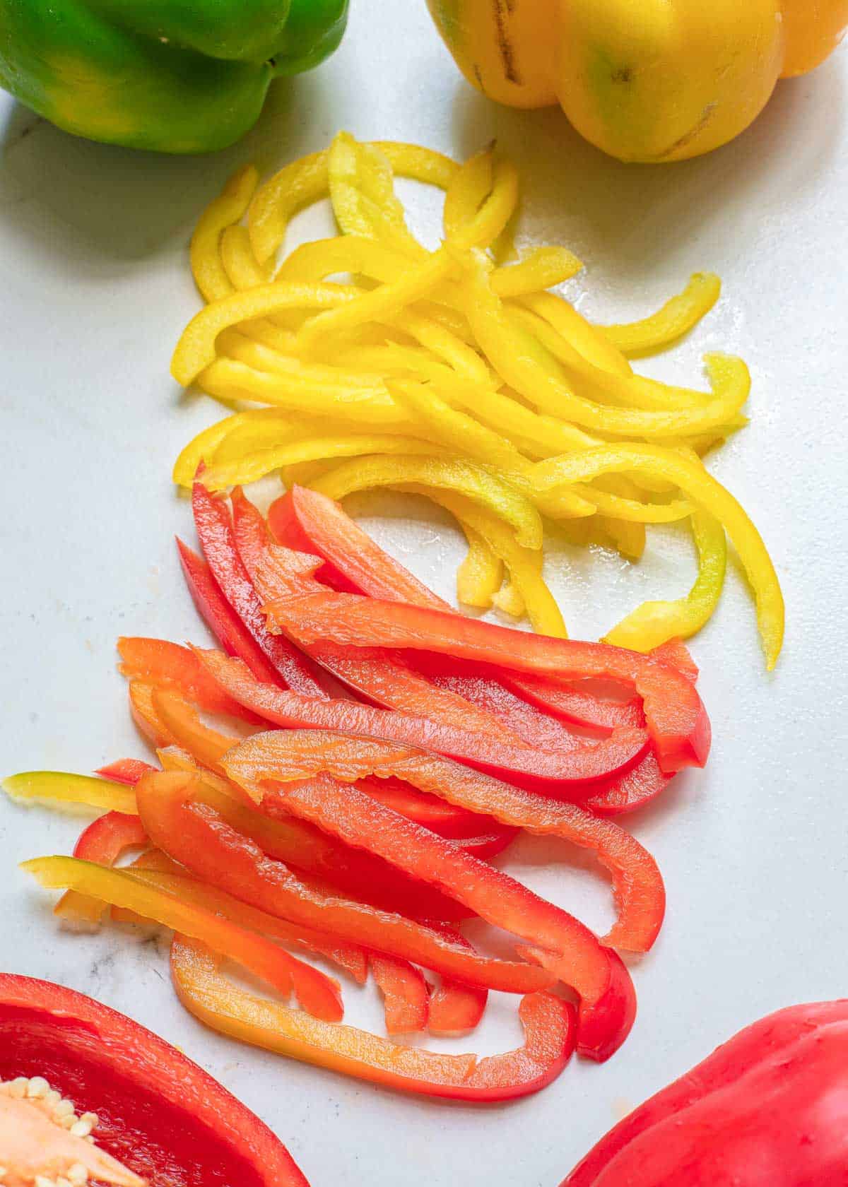 Yellow and red bell peppers cut into strips.