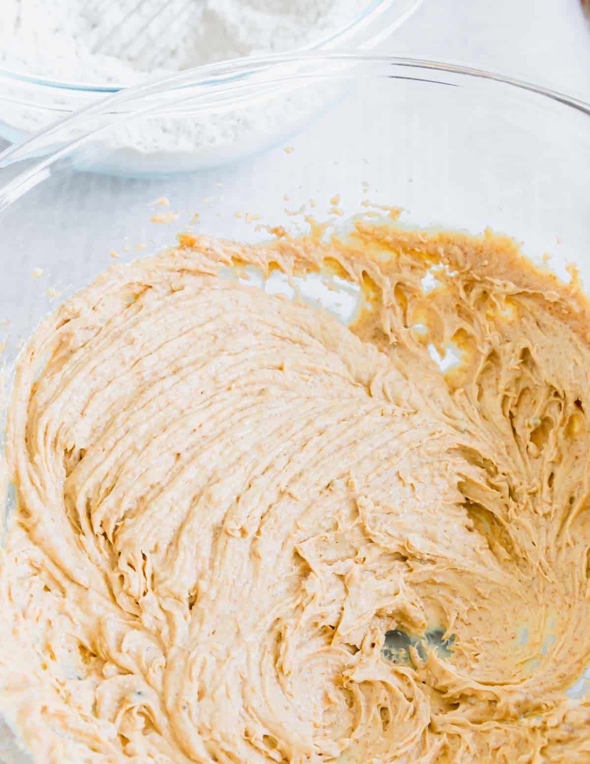 Peanut butter cookie dough in a glass bowl.