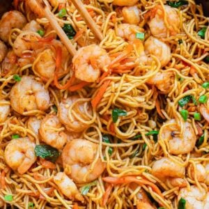 Lo mein with shrimp in a skillet with chop sticks.