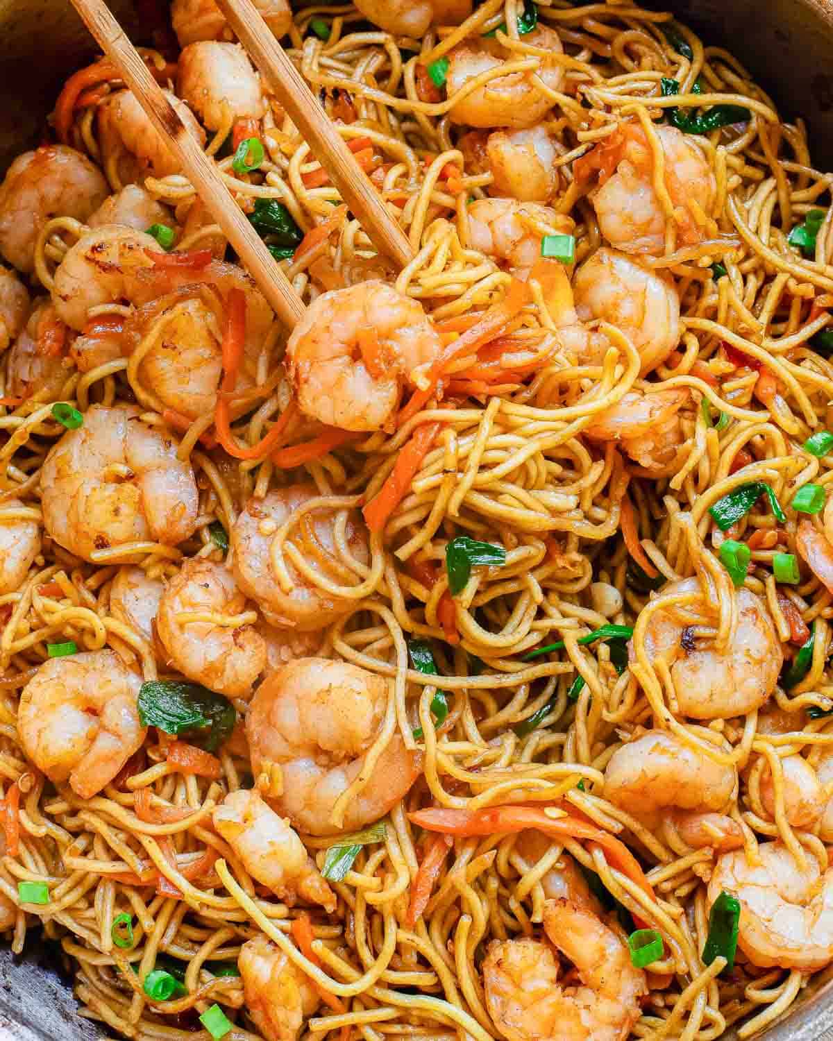 Lo mein with shrimp in a skillet with chop sticks.