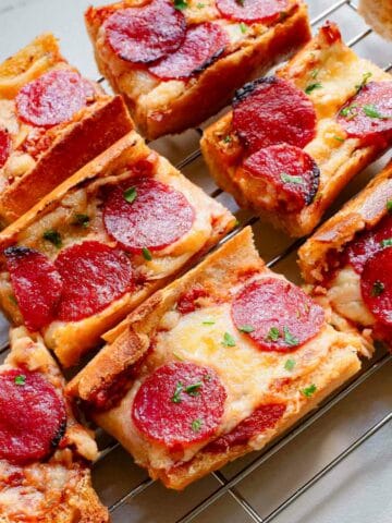 Pepperoni garlic pizza bread on a cooling rack.