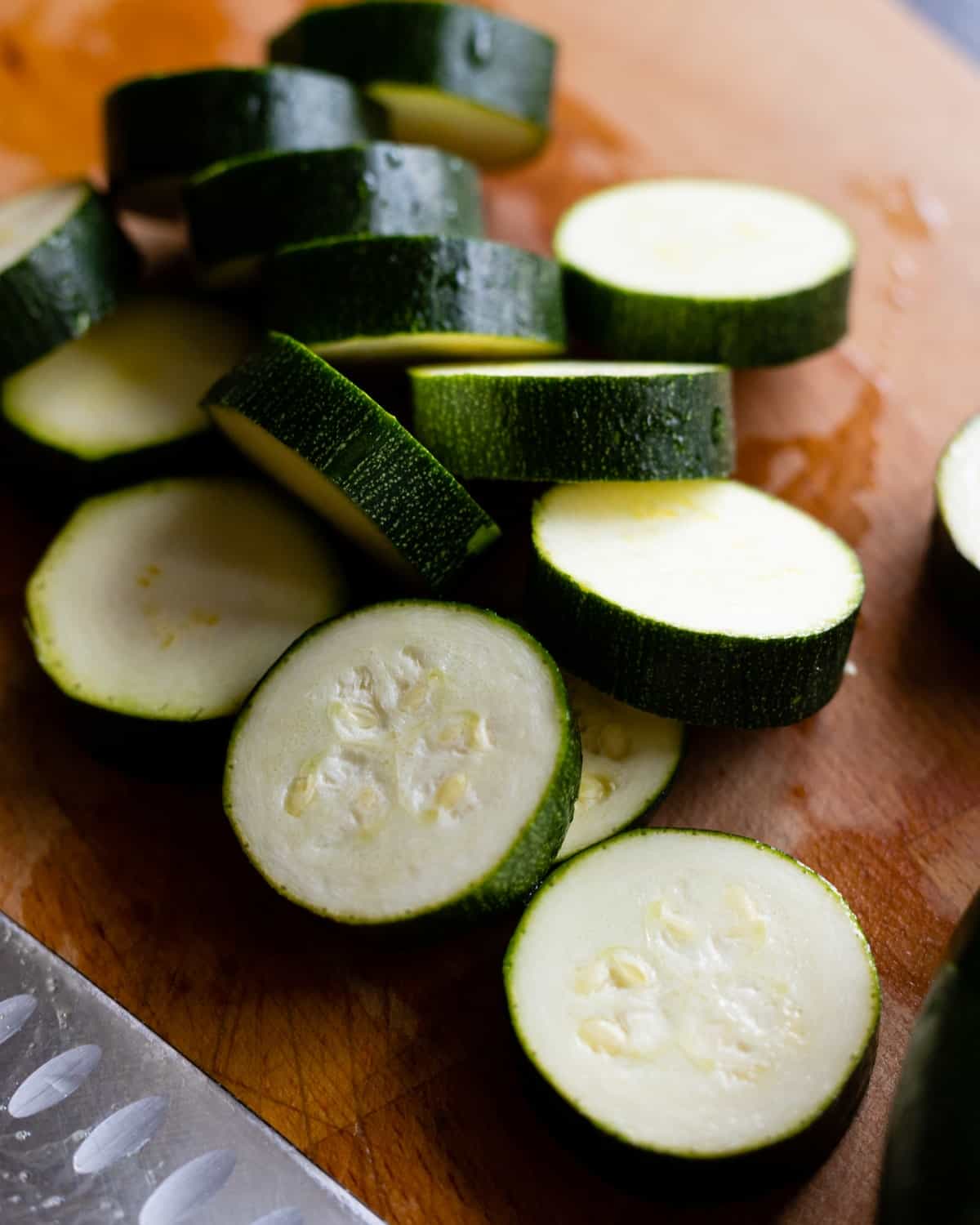 Sliced zucchini on a cutting board.